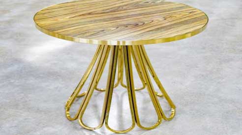 Round table with woven brass base and figured timber top